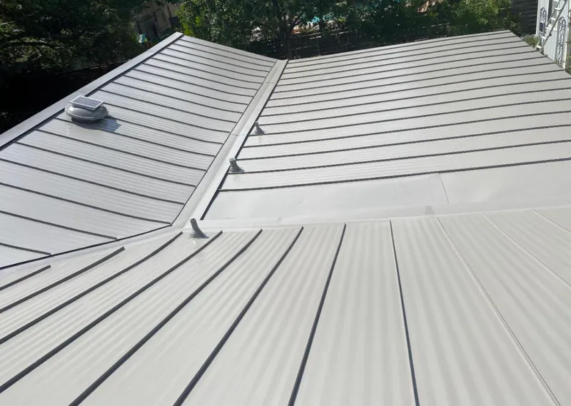 Solar attic fan installed on a metal roof for Roof Ventilation in Doral